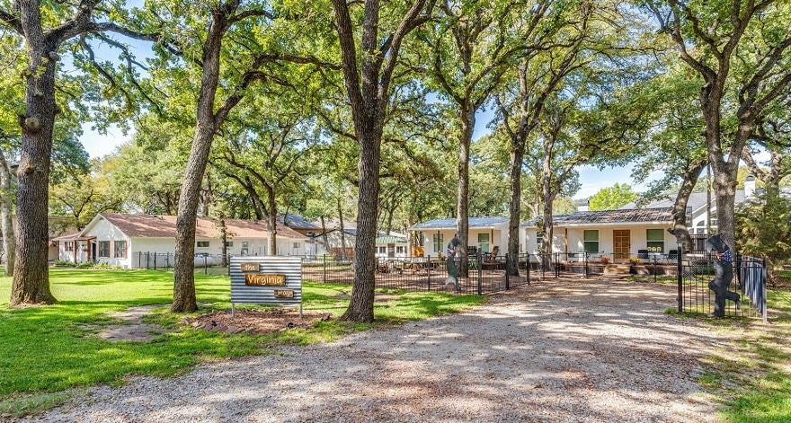 white house under lots of trees